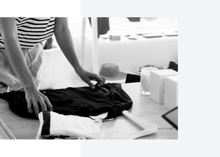 Close-up photo of retail assistant folding clothes