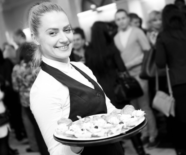 catering assistant with food