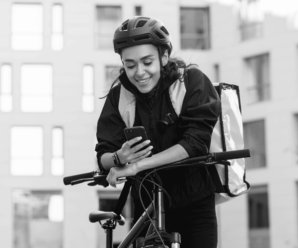 A black and white image of an e-bike delivery rider